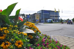 Kukkaistutus, jonka takaa näkyy Söderkullan keskustaa ja katua.