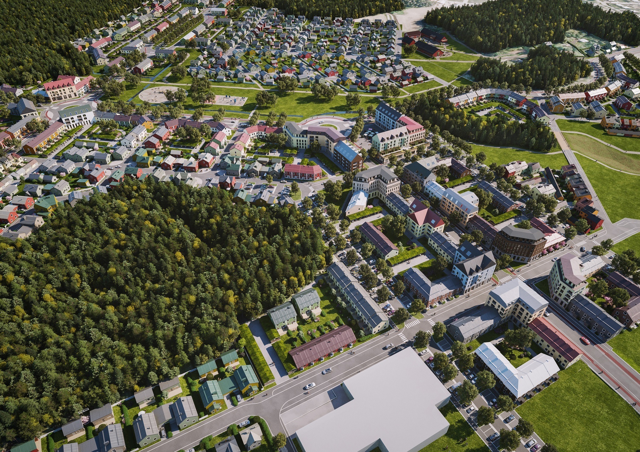 Flygbild över ett bostadsområde och skogsområde.