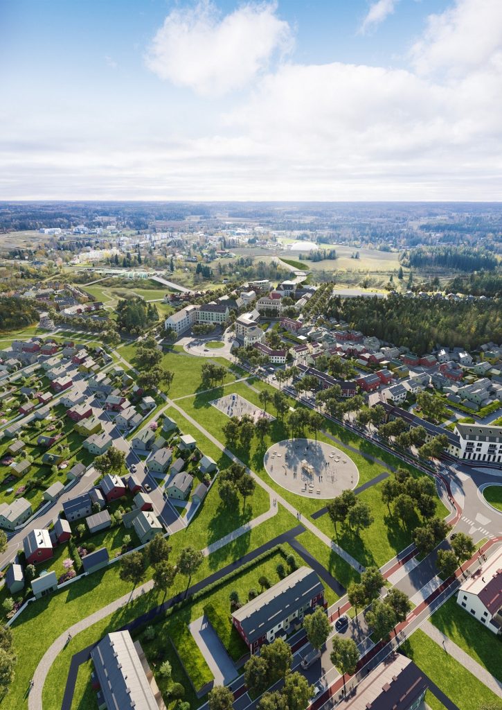 Flygbild över ett bostadsområde och skogsområde.